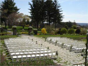 garden filled with white chairs for wedding