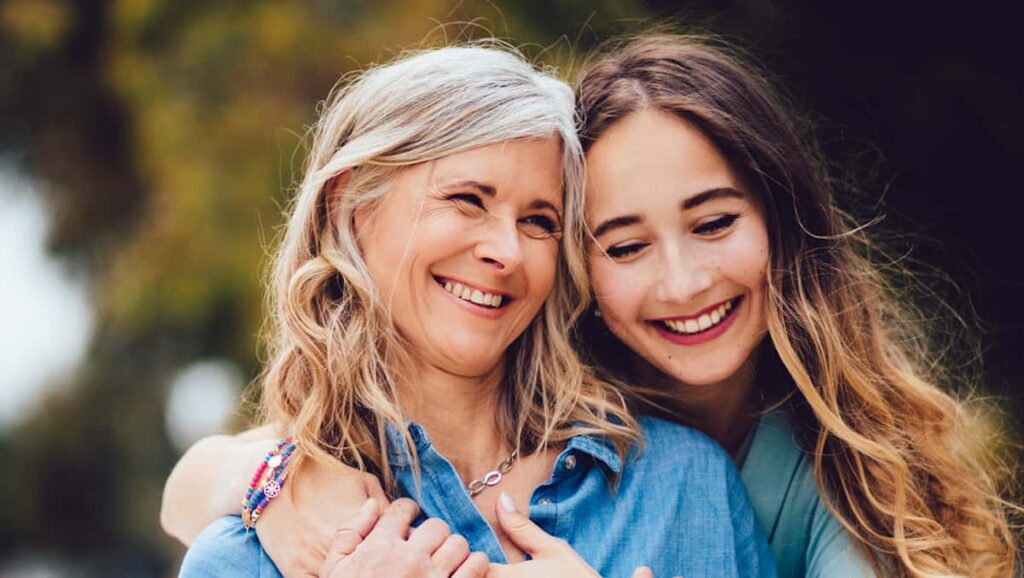 A younger women hugging her mother