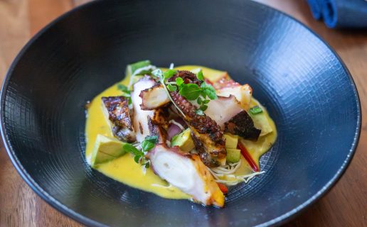 Octopus dish in a black bowl