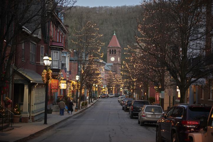 A street of buildings lit up with christmas lighs during the jim thorpe winterfest